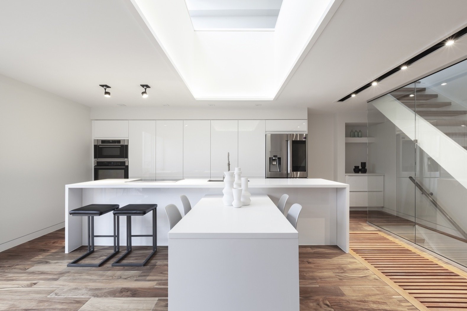 for-a-clean-and-bright-finish-the-light-filled-kitchen-is-fitted-with-white-quartz-countertops-and-high-gloss-white-ikea-cabinetry